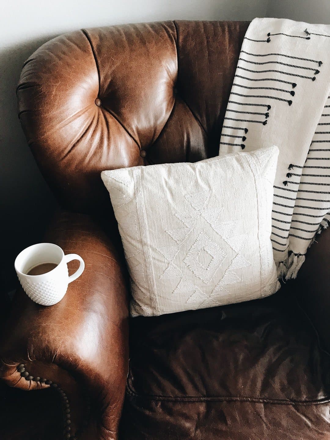 Leather couch and a cup of coffee in a calm office, the setting for an unhurried medication follow-up visit