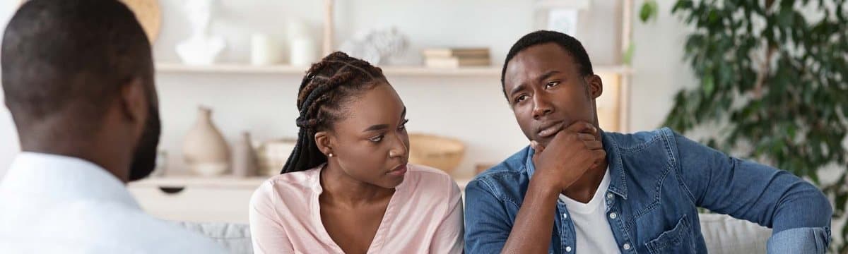 Couple talking with a counselor during a couples counseling session focused on communication