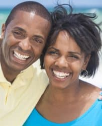 Happy engaged couple smiling together while preparing for marriage through premarital counseling